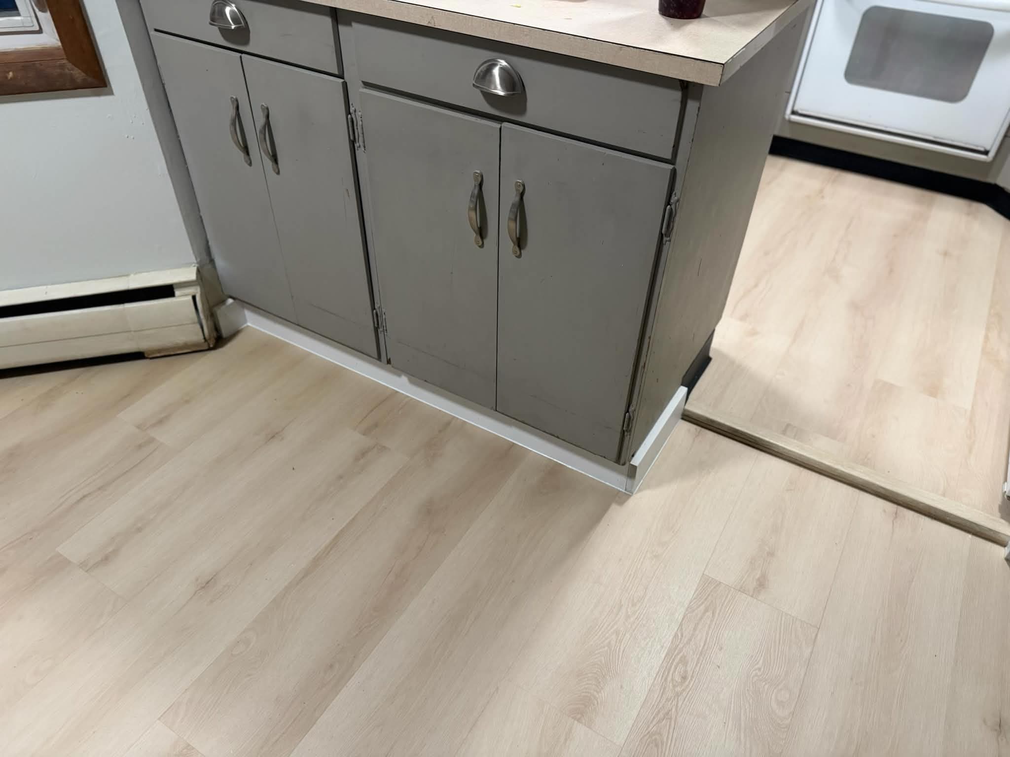 LVP flooring around kitchen cabinets
