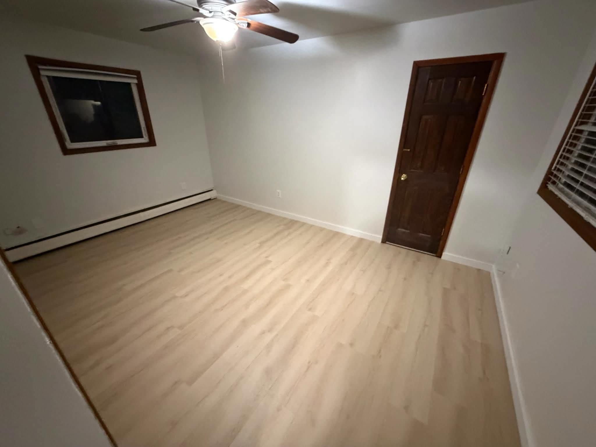 LVP flooring in bedroom with ceiling fan