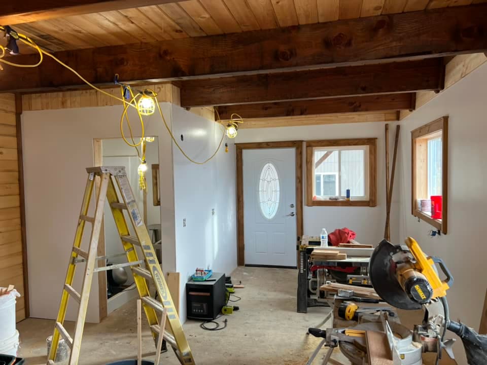 Interior remodel with exposed cedar beams and custom trim work in Juneau