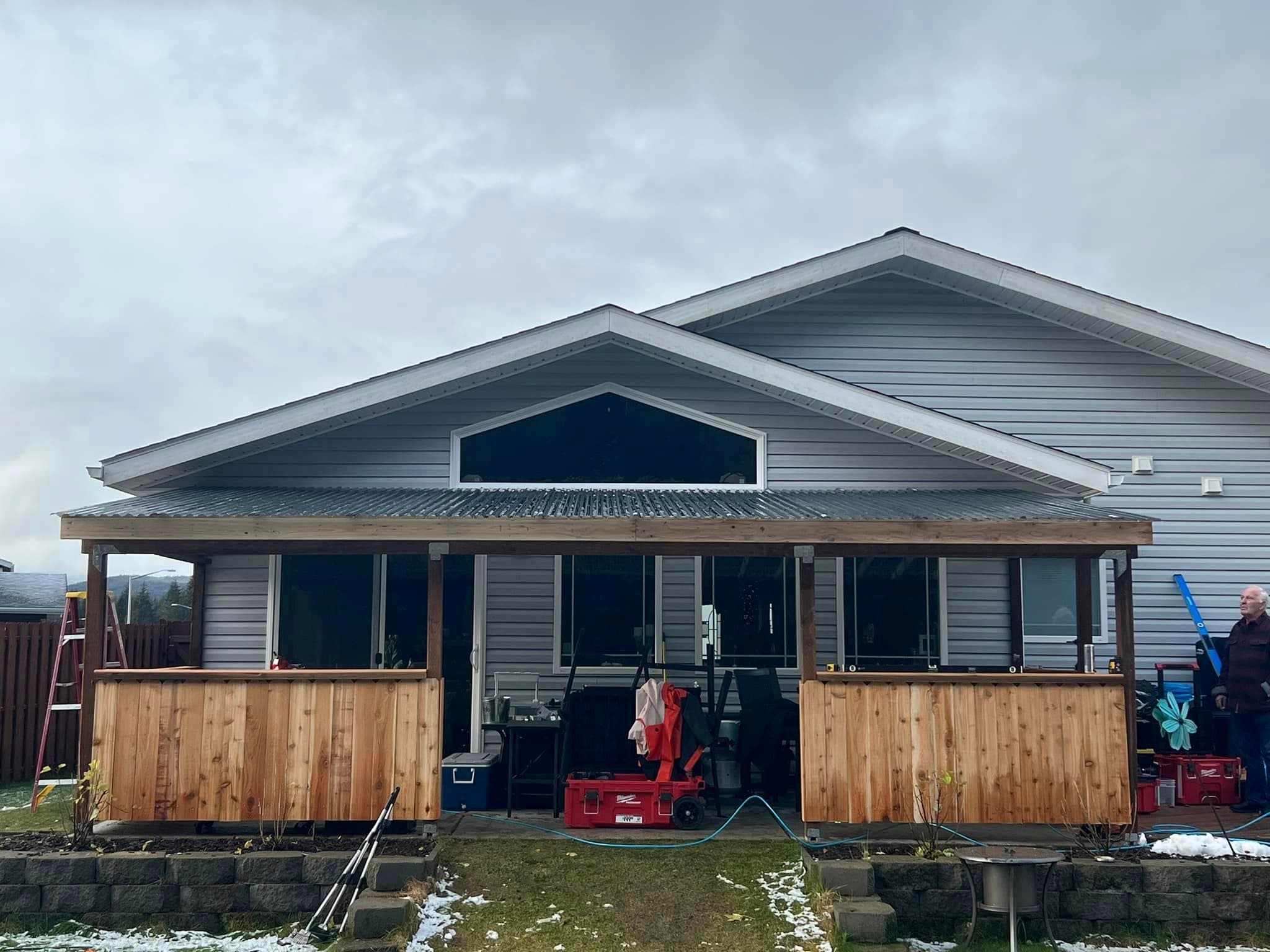 Covered porch with cedar railing built by Sourdough Construction in Juneau