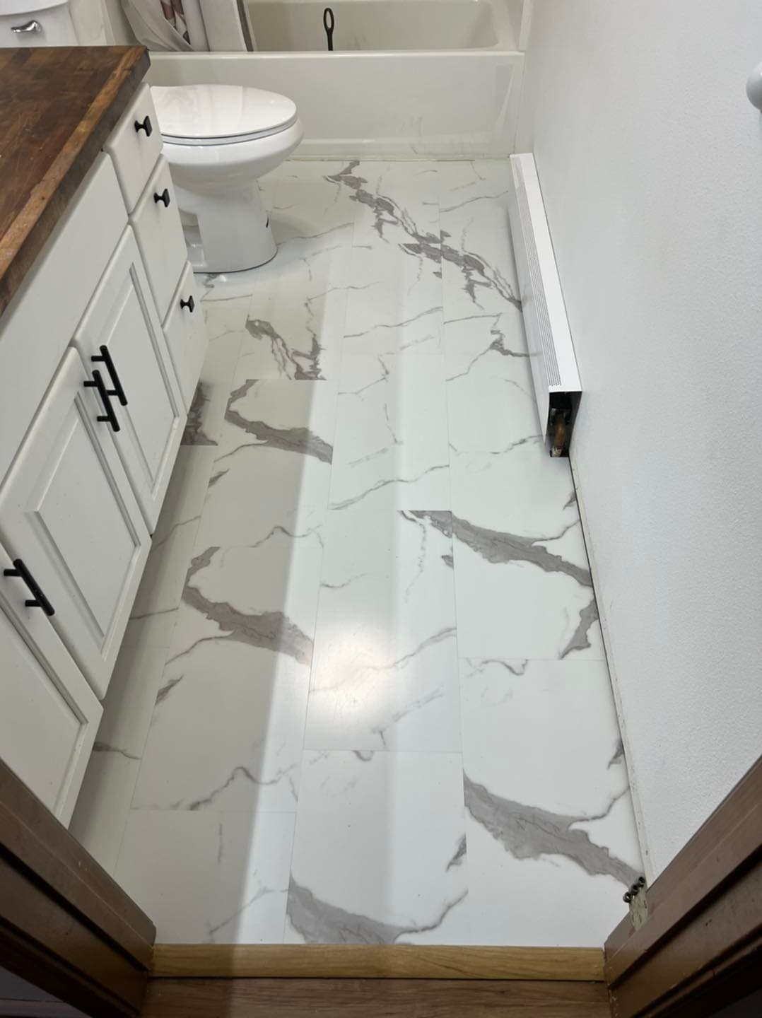 Bathroom remodel with marble-look tile flooring in Juneau home