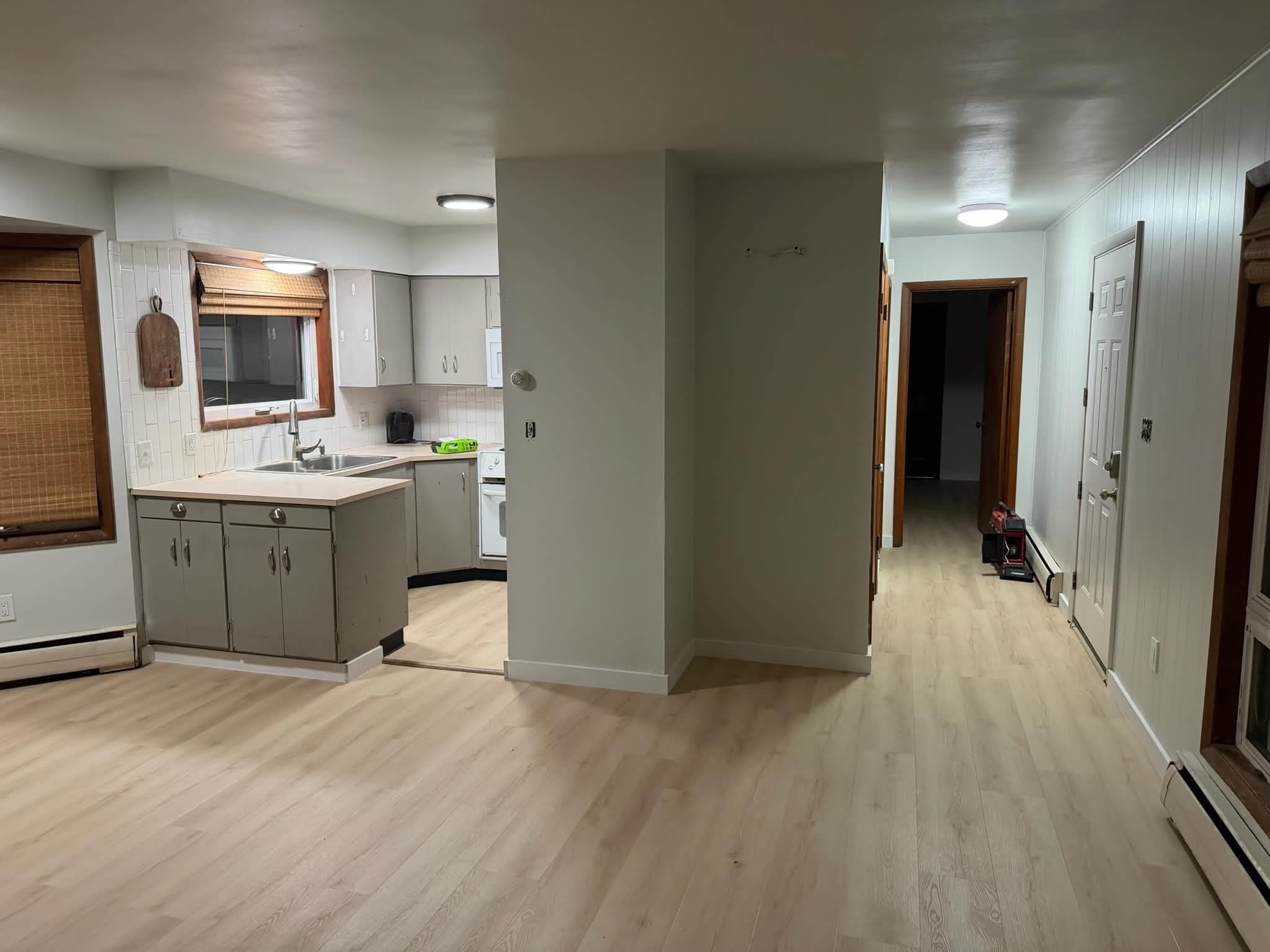 LVP flooring installed throughout open-concept kitchen and living area in Juneau home